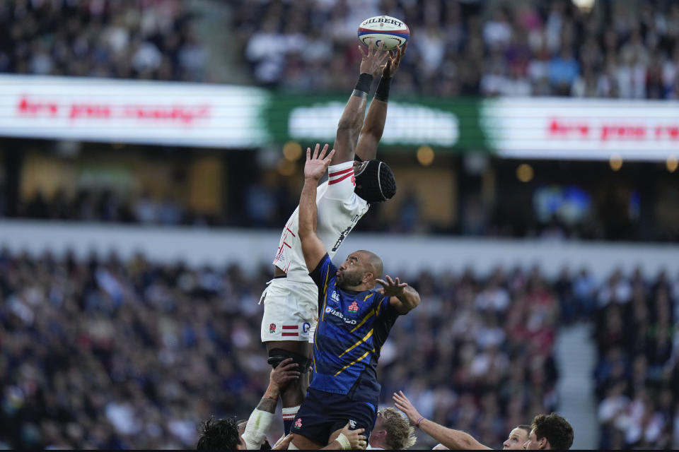 England's Maro Itoje, top, catches the ball during the international rugby union match between England and Japan at Twickenham Stadium, London, Saturday, Nov. 12, 2022. (AP Photo/Alastair Grant)
