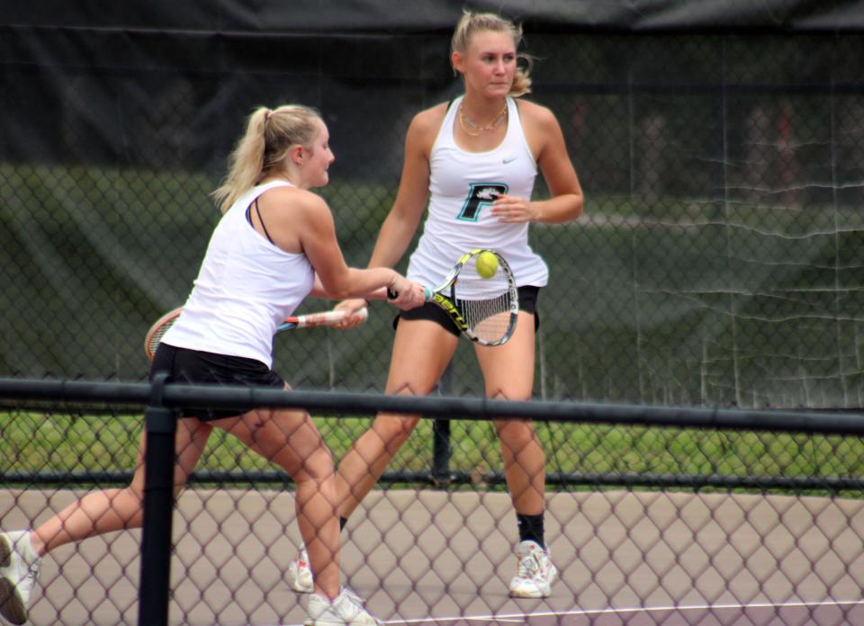 Providence's Saylor Clough and Claire Caven attempt to return a serve. The seniors compete in individual doubles.