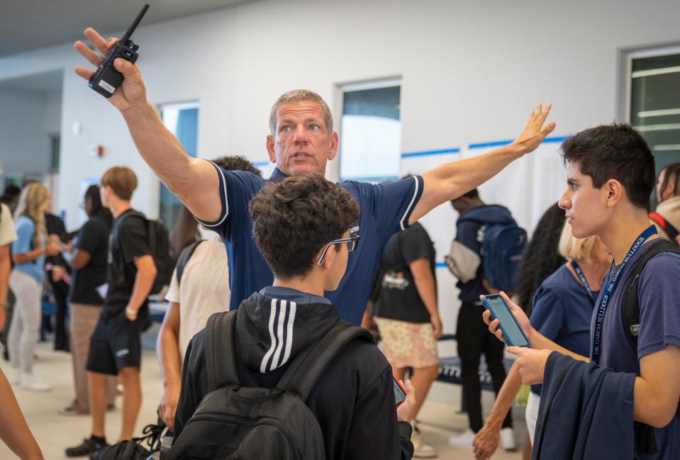 Teacher Eric Luchina directs students to their classes on the first day of school at Dr. Joaquin Garcia High School in western Lake Worth Beach, Florida on August 10, 2023.