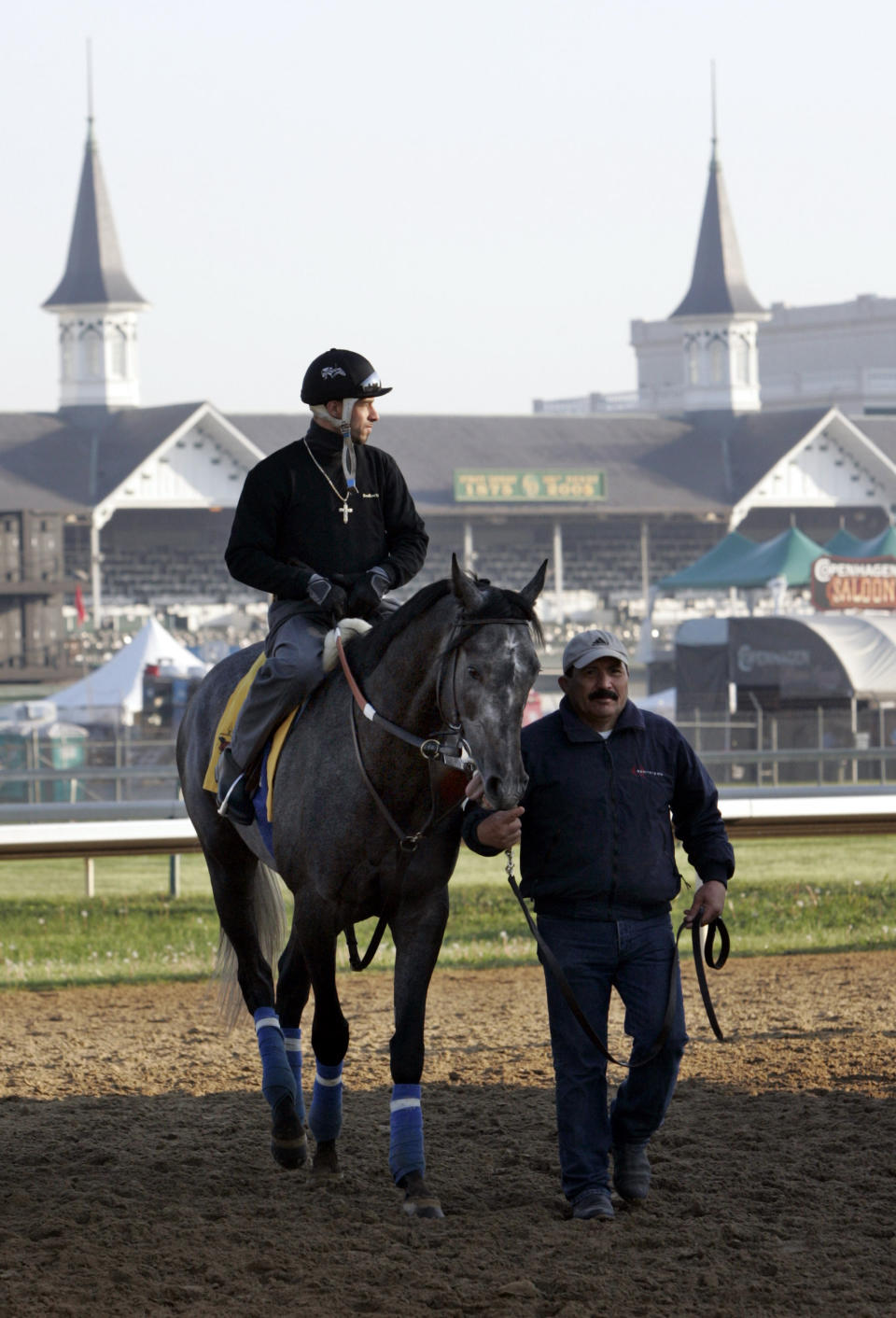 FILE - Kentucky Derby entrant Giacomo, with exercise rider Frankie Herrate up, is led off the track Friday, May 6, 2005 at Churchill Downs in Louisville, Ky. (AP Photo/Al Behrman, File)