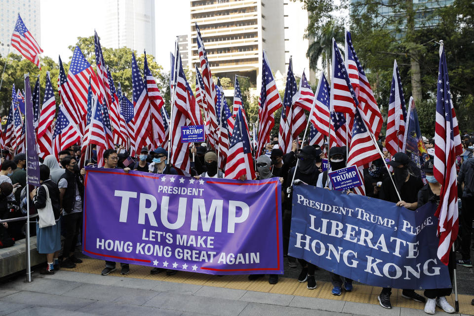 Protesters prepare to march to U.S. Consulate during a rally in Hong Kong, Sunday, Dec. 1, 2019. Hong Kong protesters carrying American flags and banners appealing to President Donald Trump are rallying in the semi-autonomous Chinese territory. (AP Photo/Vincent Thian)