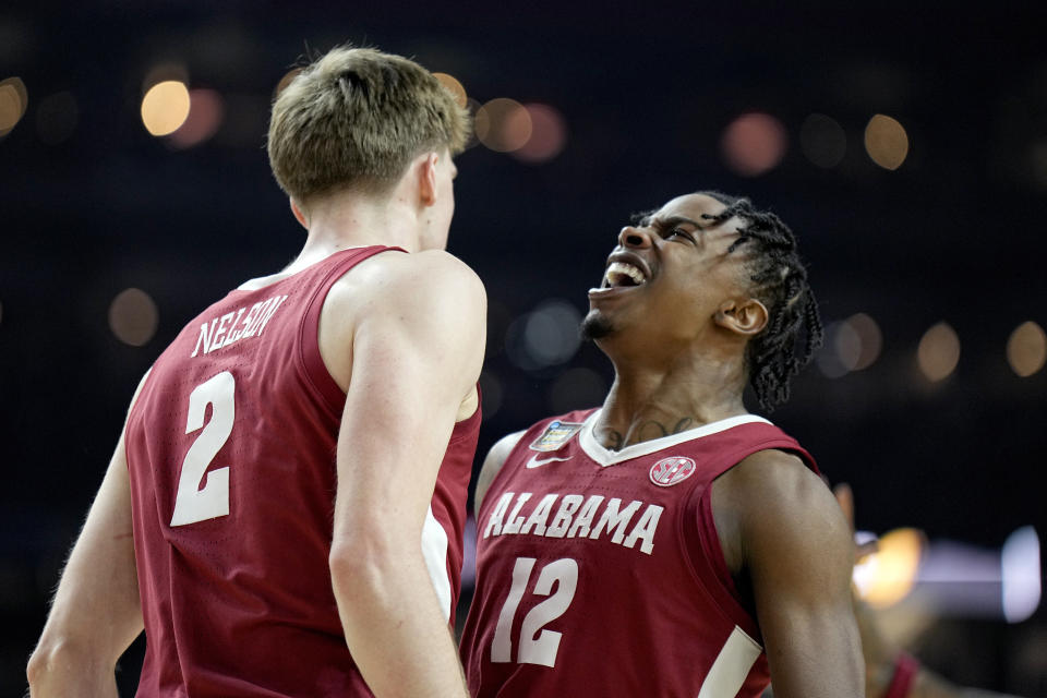 Alabama forward Grant Nelson (2) and guard Latrell Wrightsell Jr. (12) celebrate a basket against UConn during the second half of the NCAA college basketball game at the Final Four, Saturday, April 6, 2024, in Glendale, Ariz. (AP Photo/Brynn Anderson )
