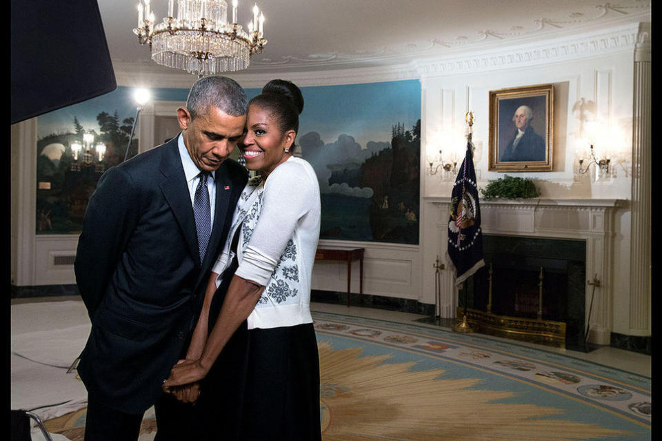 First lady Michelle Obama snuggles against President Barack Obama before a videotaping for the 2015 World Expo in the Diplomatic Reception Room of the White House on March 27, 2015.