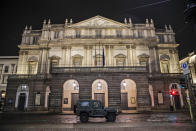 A military vehicle drives past La Scala opera theater in Milan, northern Italy, early Sunday, Oct. 25, 2020. Since the 11 p.m.-5 a.m. curfew took effect last Thursday, people can only move around during those hours for reasons of work, health or necessity. (AP Photo/Luca Bruno)