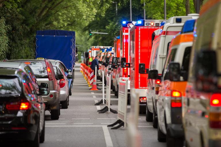 Ambulances line up in front of a building of social services during an evacuation of 20,000 from their homes in Cologne, western Germany, on May 27, 2015