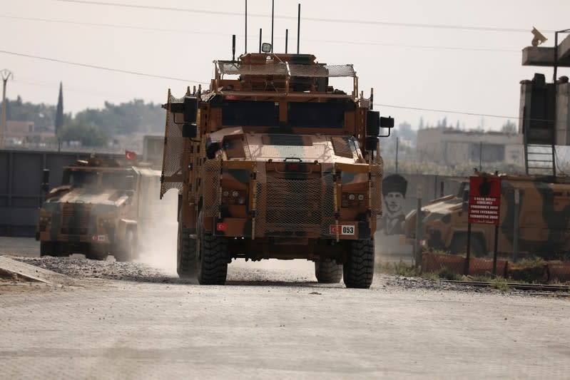 Turkish soldiers in military vehicles return from the Syrian town of Tal Abyad, as they are pictured on the Turkish-Syrian border in Akcakale