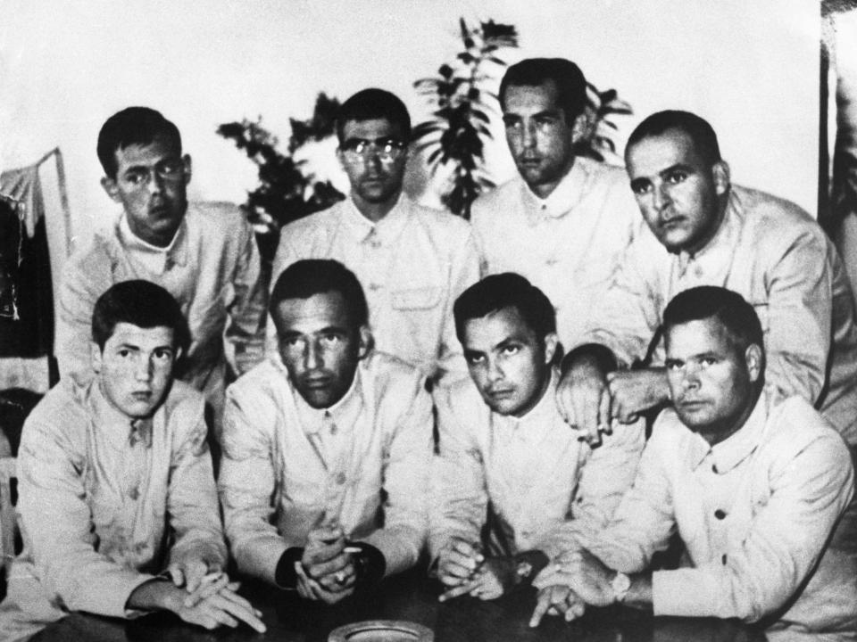 Men of the captured crew of the USS Pueblo subtly raising their middle fingers in a photograph taken in North Korea.