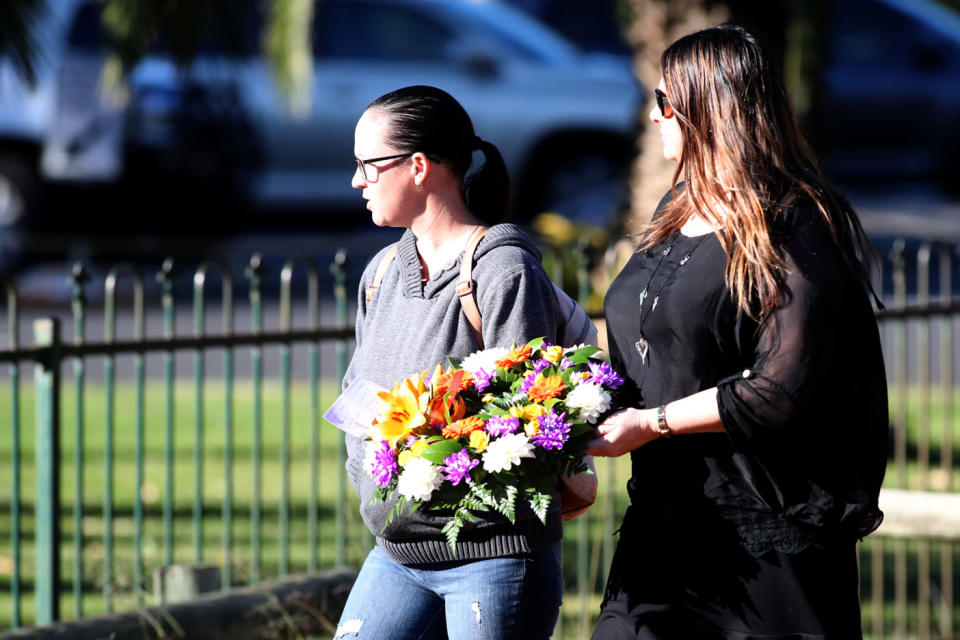 Many young families brought flowers to Wednesday’s service. Photo: AAP