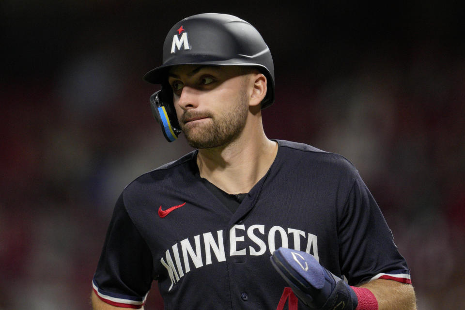 Minnesota Twins' Edouard Julien scores on a wild pitch by Cincinnati Reds relief pitcher Derek Law in the eighth inning of a baseball game in Cincinnati, Tuesday, Sept. 19, 2023. (AP Photo/Jeff Dean)