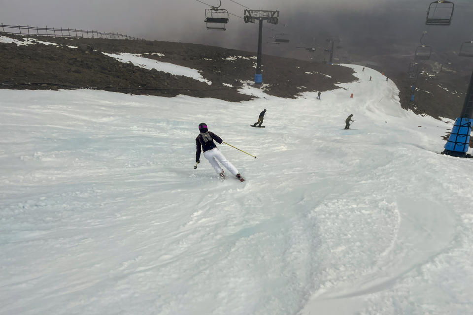FILE - Skiers make the most of the very little snow at the Tūroa ski field, on Mt Ruapehu, New Zealand on Sept. 22, 2022. 2022 was New Zealand's hottest year on record, breaking a record set just one year ago by a significant margin. Scientists say a La Nina weather system and climate change are among the factors that led to the result. (AP Photo/Nick Perry, File)