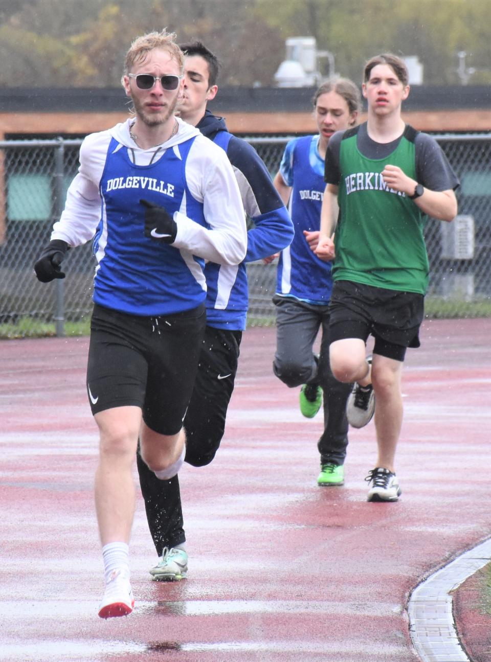 Dolgeville Blue Devil Jayden Kamp (left) leads the 3,200-meter run during Wednesday's duel meet against Herkimer.