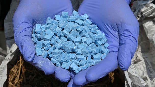 PHOTO: In this Nov. 5, 2019, file photo, a police officer shows synthetic drug MDMA, also known as ecstasy, during a press conference in Jakarta. (Adek Berry/AFP via Getty Images, FILE)