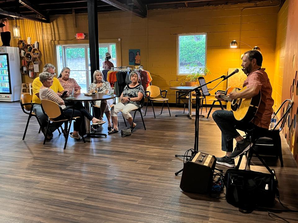 Local favorite Tom Fisch performs at The Buzz, a sober bar, cafe and coffee shop in downtown Hendersonville, on July 1, 2023.
