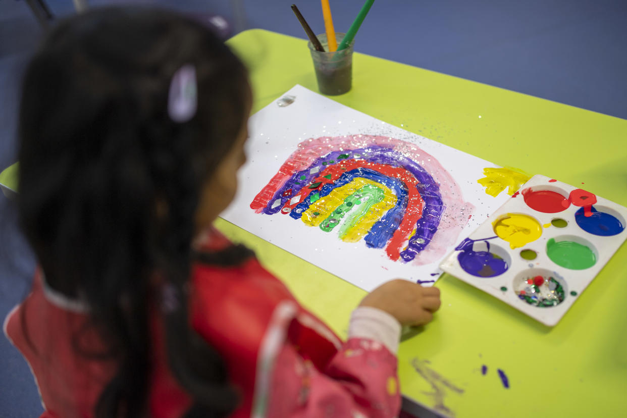 LONDON, ENGLAND - JUNE 10: A child maintains social distancing measures while painting a rainbow during a lesson at Earlham Primary School, which is part of the Eko Trust on June 10, 2020 in London, England. As part of Covid-19 lockdown measures, Earlham Primary School is teaching smaller ‘bubbles’ of students, to help maintain social distancing measures. School staff have put into place many safety measures such as corridor signage for a one way system, regular supervised handwashing, temperature checks on arrival and enhanced cleaning regimes to keep pupils and staff as safe as possible. Bubbles of pupils are limited to six and each have their own well-ventilated space. The Government have announced it is set to drop plans for all English primary pupils to return to school before the end of the summer. (Photo by Justin Setterfield/Getty Images)