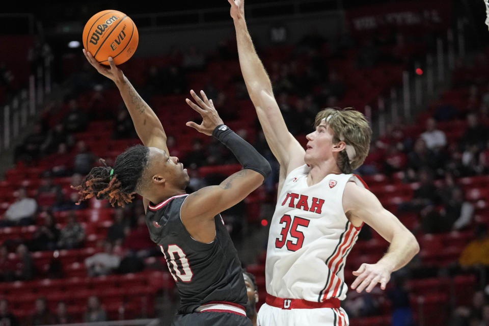 Jacksonville State forward Juwan Perdue (10) shoots as Utah center Branden Carlson (35) defends during the first half of an NCAA college basketball game Thursday, Dec. 8, 2022, in Salt Lake City. (AP Photo/Rick Bowmer)