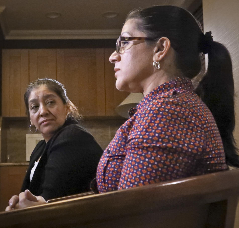 Victorina Morales, left, listens as Sandra Diaz, right, recall her experience working at President Donald Trump's golf resort in Bedminster, N.J., during an interview, Friday Dec. 7, 2018, in New York. Both Morales and Diaz say they used false legal documents to get hired at the resort and supervisors knew it. (AP Photo/Bebeto Matthews)