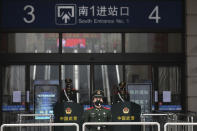 FILE - In this Jan. 23, 2020, file photo, paramilitary police stand guard outside the closed Hankou Railway Station in Wuhan in central China's Hubei Province. A 10-member team of international researchers from the World Health Organization hopes to find clues as to the origin of the coronavirus pandemic in the central Chinese city of Wuhan where the virus was first detected in late 2019. (Chinatopix via AP, File)