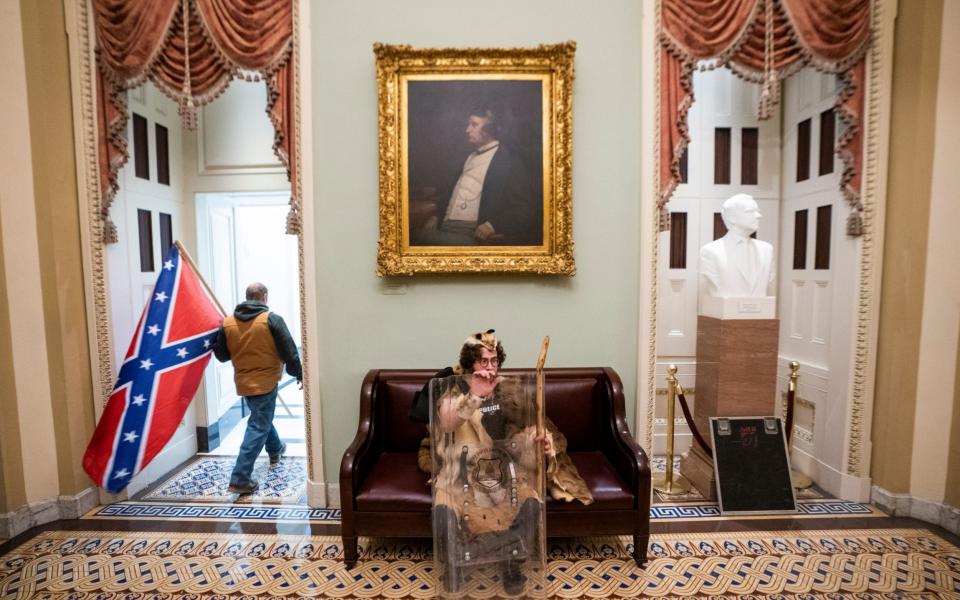 Protesters carrying Confederate flags entered the Capitol on Wednesday - EPA