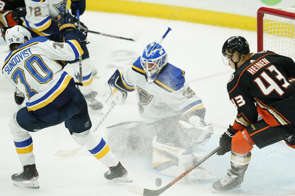 St. Louis Blues goaltender Ville Husso (35) blocks a shot by Anaheim Ducks center Danton Heinen (43) during the third period of an NHL hockey game Sunday, Jan. 31, 2021, in Anaheim, Calif. (AP Photo/Ashley Landis)