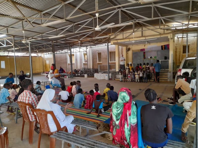 Refugees attend an event at "Dar Mariam" a Catholic church and school compound in al-Shajara district, where they took shelter, in Khartoum