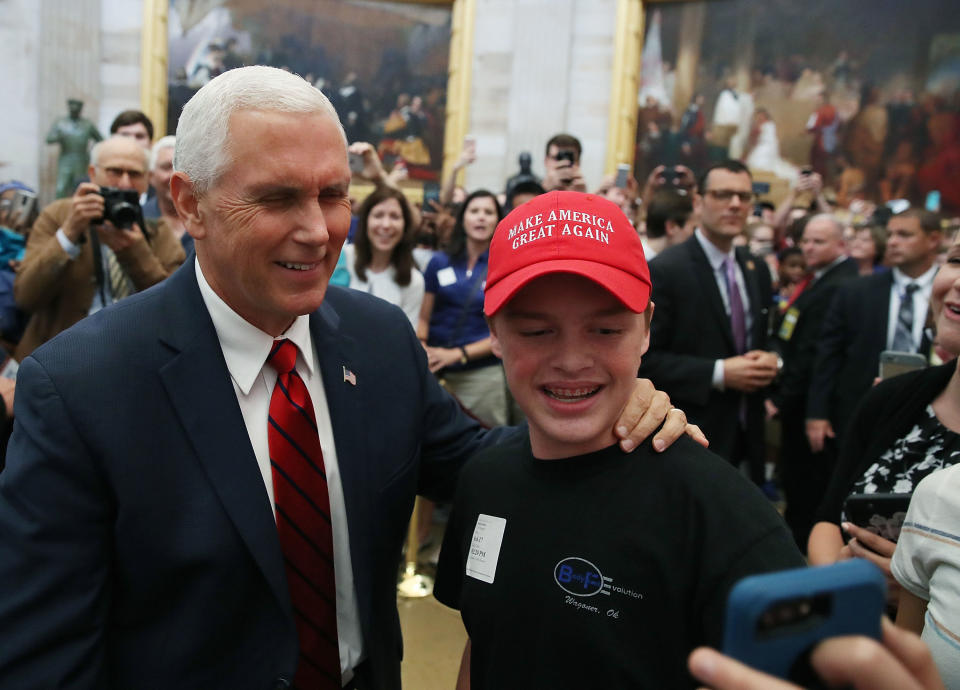 Vice President Mike Pence takes a selfie with a tourist wearing a "Make America Great Again" hat inside the U.S. Capitol rotunda on June 6, 2017. The vice president walked through the rotunda after attending the Senate Republican policy luncheon.