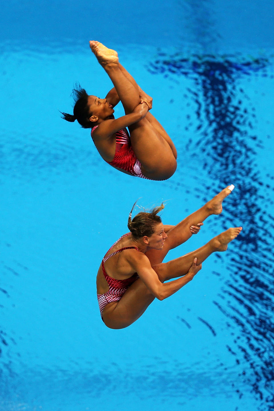 LONDON, ENGLAND - JULY 29: Emilie Heymans (Bottom) and Jennifer Abel of Canada compete in the Women's Synchronised 3m Springboard final on Day 2 of the London 2012 Olympic Games at the Aquatics Centre at Aquatics Centre on July 29, 2012 in London, England. (Photo by Clive Rose/Getty Images)