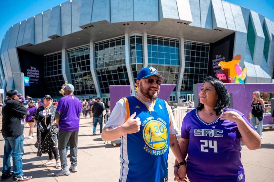 Golden State Warriors fan Rudy Solorzano, 46, has tried for years to get his partner, Raquel Aguilar (24), to switch her allegiance from the Sacramento Kings. The couple attended the first game of their teams’ NBA playoffs series at Downtown Plaza on Saturday, April 15, 2023.