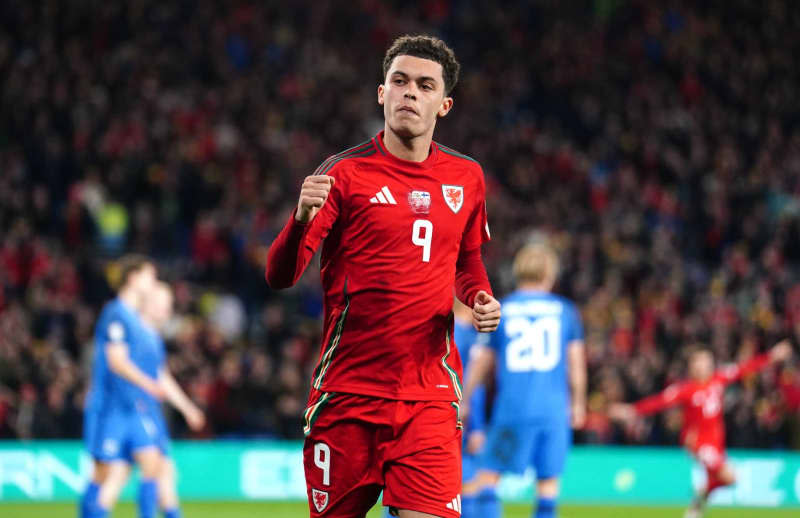 Wales' Brennan Johnson celebrates scoring his side's third goal during the UEFA Euro 2024 Qualifying play-off soccer match between Wales and Finland at the Cardiff City Stadium. David Davies/PA Wire/dpa