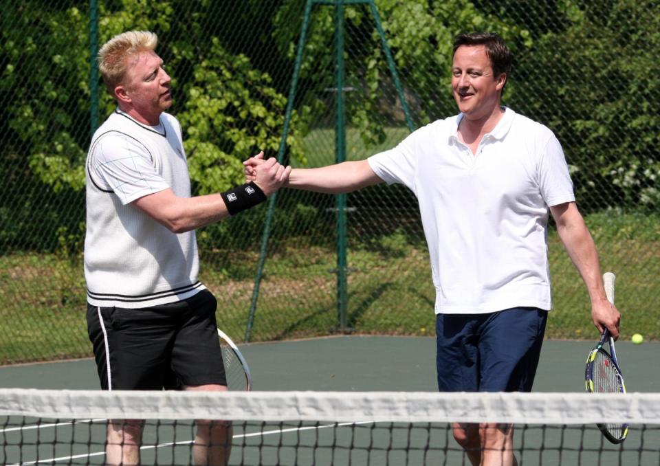 David Cameron shakes hands with Boris Becker during a charity tennis match at Chequers (PA)