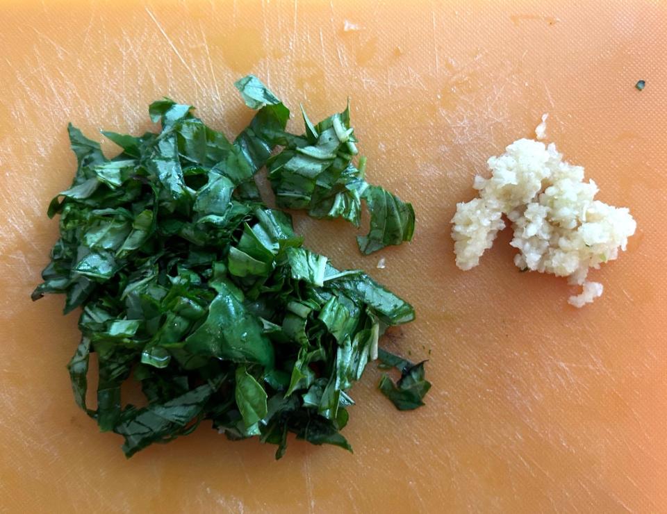 Chopping garlic and basil for Gordon Ramsay's 10-minute scampi