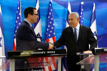 Israeli Prime Minister Benjamin Netanyahu shakes hands with U.S. Treasury Secretary Steven Mnuchin prior to their meeting in Jerusalem October 21, 2018. Gali Tibbon/Pool via REUTERS