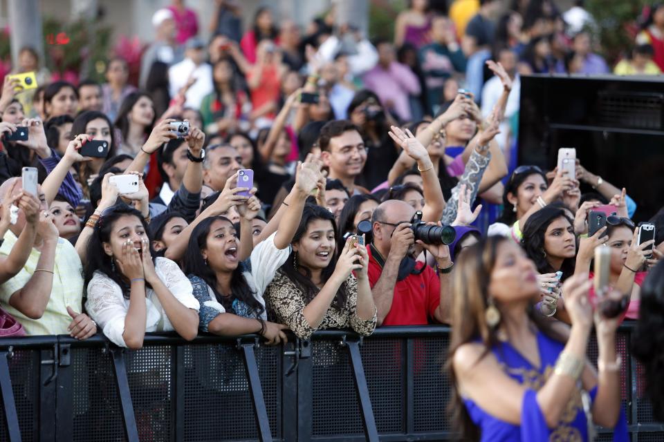 Fans scream as Indian film stars walk the green carpet as they arrive for the 15th annual International Indian Film Awards on Saturday, April 26, 2014, in Tampa, Fla. (AP Photo/Brian Blanco)