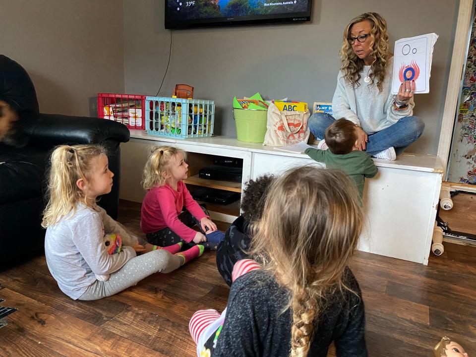 Child care provider Wendy Tilma leads morning circle time with her five charges for the day — ages 1 to 5 — at her home in Byron Center, Michigan.