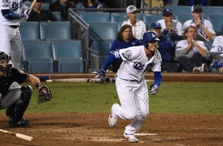 Oct 16, 2018; Los Angeles, CA, USA; Los Angeles Dodgers center fielder Cody Bellinger (35) hits an RBI single to defeat the Milwaukee Brewers in the thirteenth inning in game four of the 2018 NLCS playoff baseball series at Dodger Stadium. Mandatory Credit: Robert Hanashiro-USA TODAY Sports