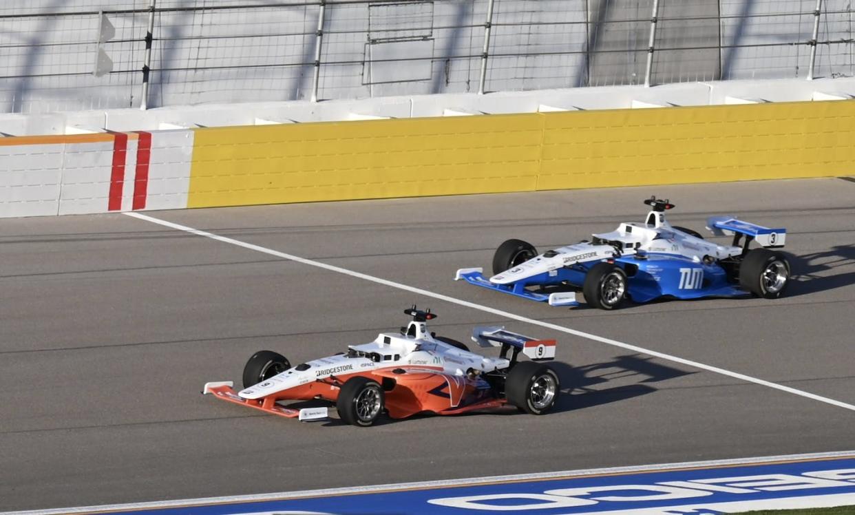 An autonomous race car built by the Technical University of Munich prepares to pass the University of Virginia's entrant. Cavalier Autonomous Racing, University of Virginia, <a href="http://creativecommons.org/licenses/by-nd/4.0/" rel="nofollow noopener" target="_blank" data-ylk="slk:CC BY-ND;elm:context_link;itc:0;sec:content-canvas" class="link ">CC BY-ND</a>