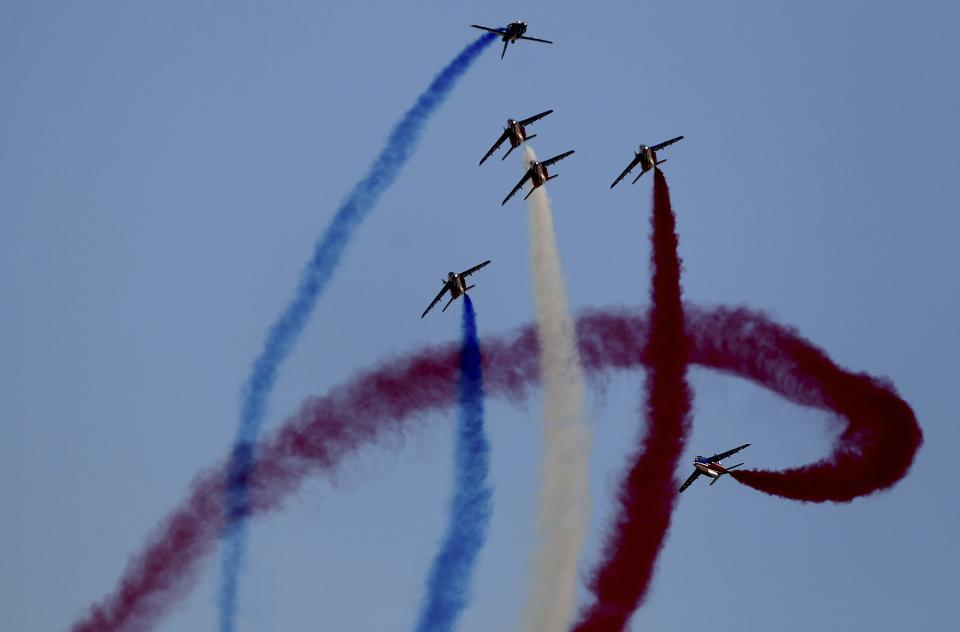 French aircrafts of the Patrouille de France spray colored smoke during a performance on the opening day of the Dubai Airshow in Dubai, United Arab Emirates, Sunday, Nov. 17, 2019. (AP Photo/Kamran Jebreili)