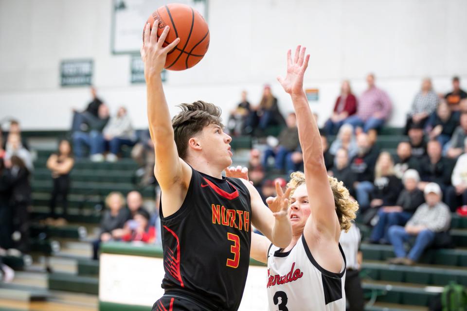 North Eugene guard Joey Banry puts up a shot over North Medford guard Easton Curtis as the North Eugene Highlanders take on North Medford Friday, Dec. 8, 2023, at Sheldon High School in Eugene.