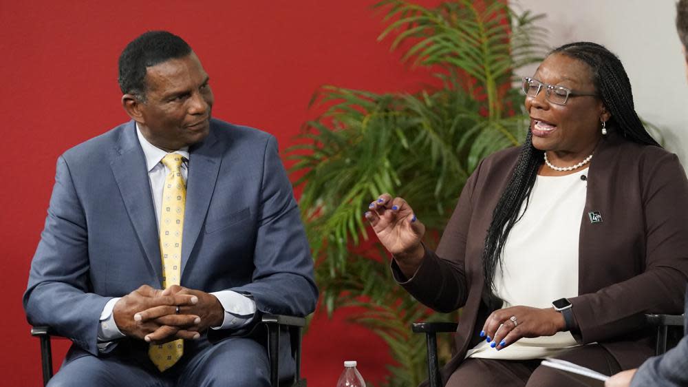 U.S. Rep. Burgess Owens, left, debates with Democrat Darlene McDonald, Friday, Oct. 28, 2022, in South Jordan, Utah, in their first and only meeting in the lead-up to the midterm elections. (AP Photo/Rick Bowmer)
