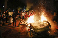 Demonstrators start a fire as they protest the death of George Floyd, Sunday, May 31, 2020, near the White House in Washington. Floyd died after being restrained by Minneapolis police officers (AP Photo/Alex Brandon)