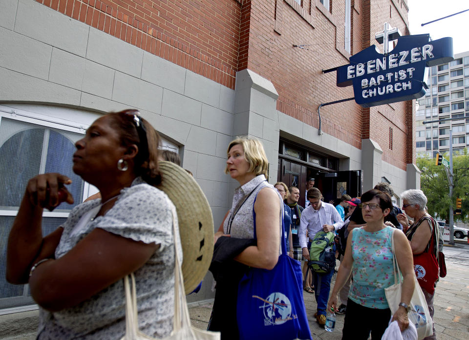 FILE - In this June 8, 2012 file photo, tourists visit the Ebenezer Baptist Church where Rev. Martin Luther King Jr. preached in Atlanta. Visitors can walk through Ebenezer Baptist Church, where King and his father both served as pastors. (AP Photo/David Goldman, File)