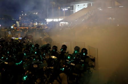 Riot police fire tear gas at anti-extradition demonstrators, after a march to call for democratic reforms in Hong Kong