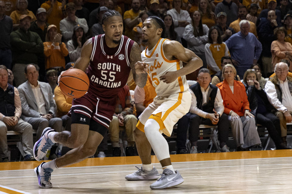 South Carolina guard Ta'Lon Cooper (55) drives against Tennessee guard Zakai Zeigler (5) during the second half of an NCAA college basketball game Tuesday, Jan. 30, 2024, in Knoxville, Tenn. (AP Photo/Wade Payne)
