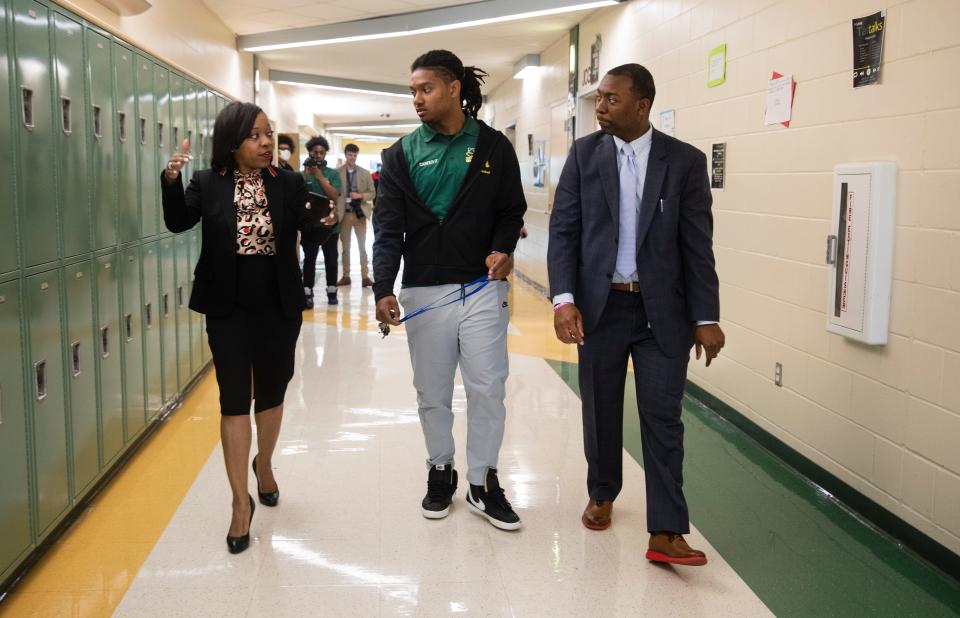 Iranetta Wright, Cincinnati Public Schools superintendent, visited students at Taft Information Technology High School on her first day on the job, May 2, 2022. She was led on the tour by Ronald Cutts,16, a junior. At right is Principal Ceair Baggett.