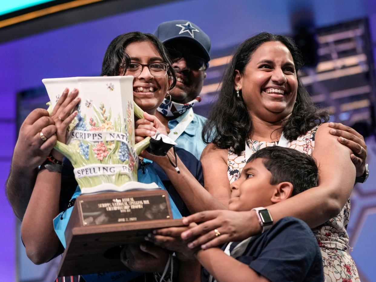 14-year-old Harini Logan from San Antonio, Texas is embraced by family after winning the Scripps National Spelling Bee