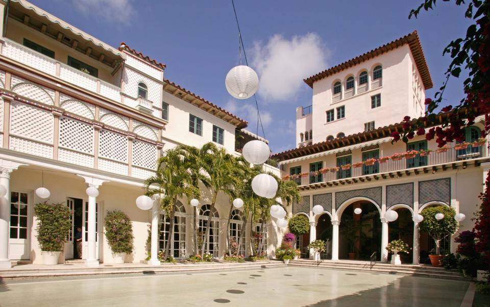 The Everglades Club's marble patio, with some of the club's apartments above, once called "maisonettes."  The tower is 6-stories tall. The club maintains 25 apartments in the building, which are rented seasonally to members and daily to members' guests.