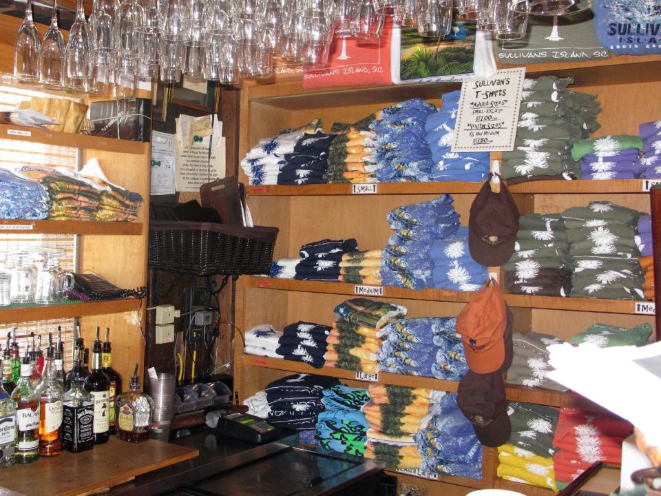 T-shirts with the logo of Sullivan's, a family-owned seafood restaurant on Sullivans Island, S.C., are seen inside the restaurant in this Sept. 12, 2013 photo. The restaurant is one of about a dozen on Sullivans Island just outside Charleston, S.C. (AP Photo/Bruce Smith)