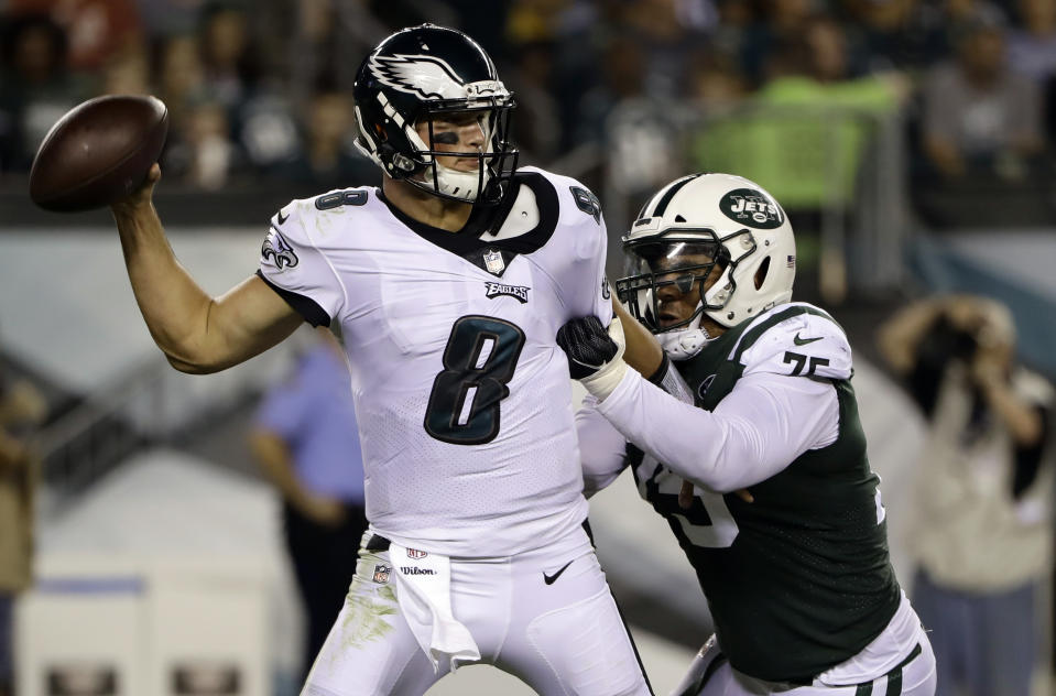 New York Jets' Xavier Cooper (75) grabs Philadelphia Eagles' Christian Hackenberg (8) during the second half of a preseason NFL football game Thursday, Aug. 30, 2018, in Philadelphia. (AP Photo/Matt Rourke)