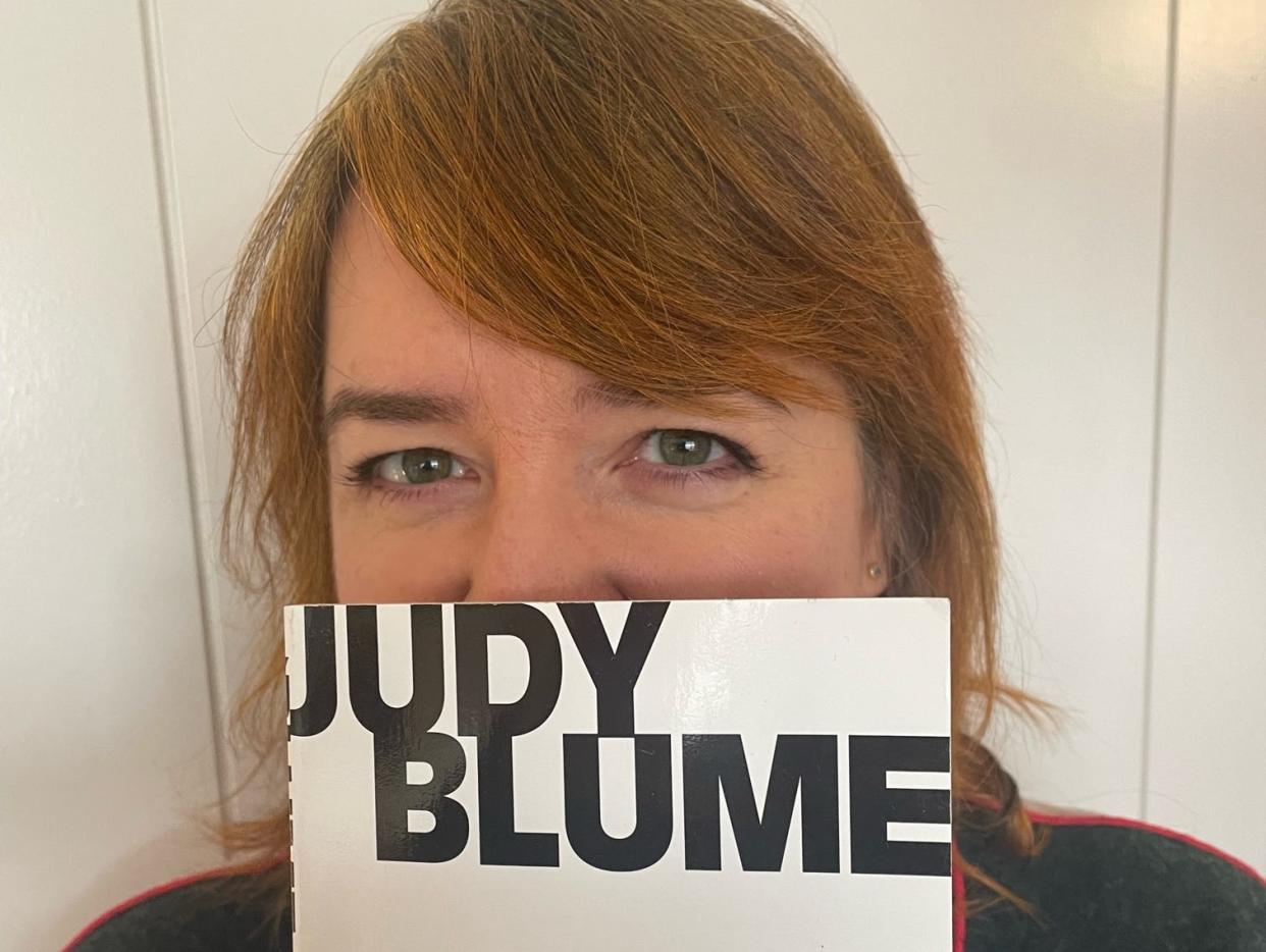 The author holding the Judy Blume book