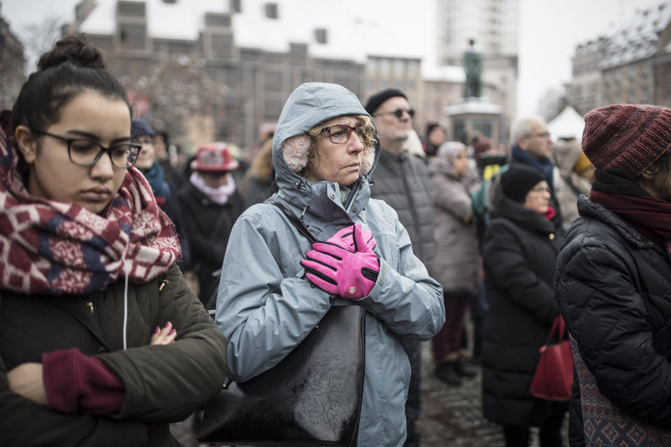 Residents react during a gathering in a central square of the eastern French city of Strasbourg, Sunday Dec.16, 2018 to pay homage to the victims of a gunman who killed four people and wounded a dozen more. The gathering was held in Kleber Square by a Christmas market and near where the gunman opened fire last Tuesday evening. (AP Photo/Jean-Francois Badias)