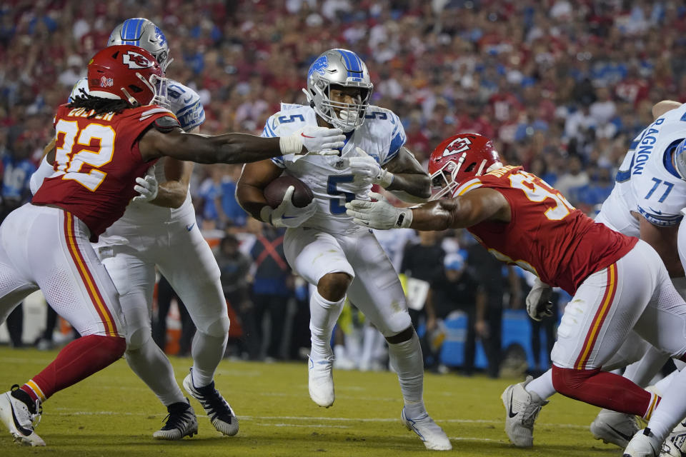 Detroit Lions running back David Montgomery (5) scores on a touchdown run as Kansas City Chiefs linebacker Nick Bolton (32) and defensive tackle Matt Dickerson, right, defend during the second half of an NFL football game Thursday, Sept. 7, 2023, in Kansas City, Mo. (AP Photo/Ed Zurga)